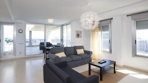 A modern living room with a sectional sofa, a coffee table, and a chandelier. - Costa Calpe by Interhome (Calpe/Calp)