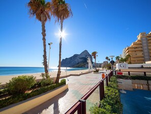 A beachfront promenade with palm trees, a clear sky, and a mountain in the background. - Topacio I by Interhome (Calpe/Calp)