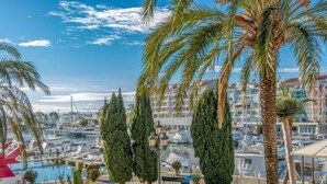 A marina with boats, palm trees, and a pool area. - Club Nautic by Interhome (Empuriabrava)