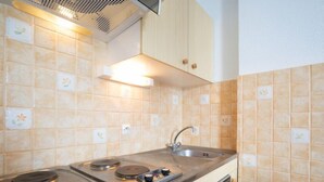 A kitchen with a gas stove, a sink, and a built-in oven. - Plein Soleil (Val Claret) by Interhome (Tignes)