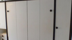 A room with a large wardrobe featuring multiple doors and drawers. - Apartment Castor by Interhome (Täsch)