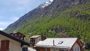 A mountain village with traditional wooden houses, a clear sky, and a snow-capped mountain in the background. - Apartment Castor by Interhome (Täsch)