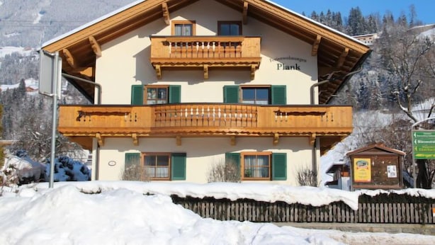 A two-story building with wooden balconies and a sign reading "Plank". - Apartment Plank by Interhome (Kaltenbach)