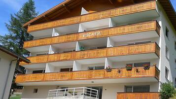 A multi-story building with balconies, labeled "VISCARIA."
