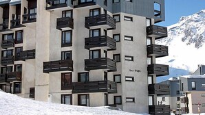A modern multi-story building with balconies and a ski slope in the background. - Les Tufs (Val Claret) by Interhome (Tignes)