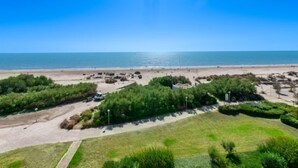 A beach view with a parking area and greenery in the foreground. - Poséidon by Interhome (La Grande Motte)