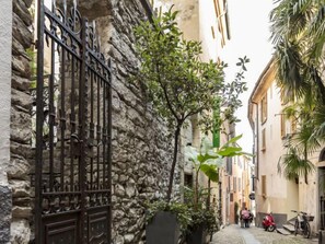 Stroll through historic streets lined with traditional architecture, lush greenery, and charming iron gates.