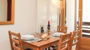 A wooden dining table set with plates, glasses, and a bread basket. - Rosablanche C22 by Interhome (Siviez-Nendaz)