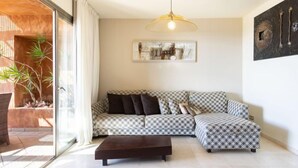 A modern living room with a checkered sofa, a coffee table, and a pendant light. - Duplex Bencomo by Interhome (Palm- Mar)