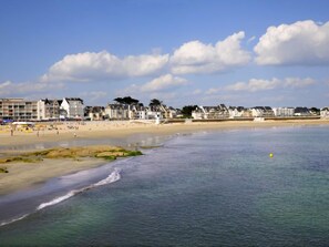 A coastal beach with buildings along the shore.