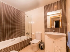 Une salle de bain avec une baignoire, des toilettes et un lavabo.