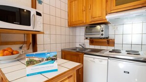 A compact kitchen with a microwave, toaster, and dishwasher. - Le Slalom (Val Claret) by Interhome (Tignes)