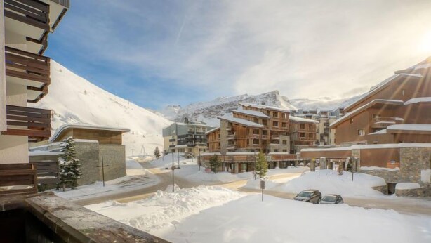 A snow-covered mountain town with wooden buildings and a clear sky. - Le Slalom (Val Claret) by Interhome (Tignes)