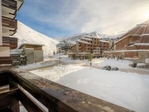 A snow-covered mountain town with wooden buildings and a clear sky. - Le Slalom (Val Claret) by Interhome (Tignes)