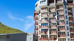 A multi-story hotel with balconies, a restaurant, and a ski rental sign. - Le Curling B (Val Claret) by Interhome (Tignes)