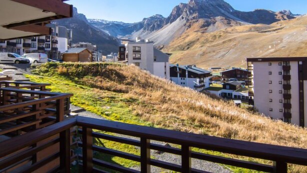 A modern building with a flat roof and a balcony, overlooking a mountainous landscape with a clear sky. - Le Curling B (Val Claret) by Interhome (Tignes)