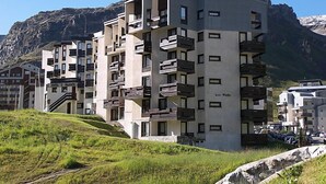 A multi-story hotel with balconies, located in a mountainous area. - Les Tufs (Val Claret) by Interhome (Tignes)