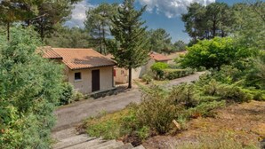 A rustic house with a tiled roof, surrounded by dense greenery and trees. - Les Cracks - Les As by Interhome (Lacanau)