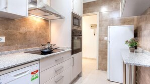 A modern kitchen with stainless steel appliances, granite countertops, and a built-in oven. - Apartment  Ronda by Interhome (L'Escala)
