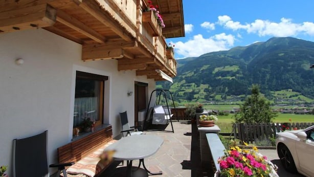 A wooden chalet with a balcony overlooking a mountainous landscape. - Christl by Interhome (Fügen)