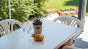 A white table with a potted succulent, three wine glasses, and a bowl of snacks. - Rheingau by Interhome (Dittishausen)
