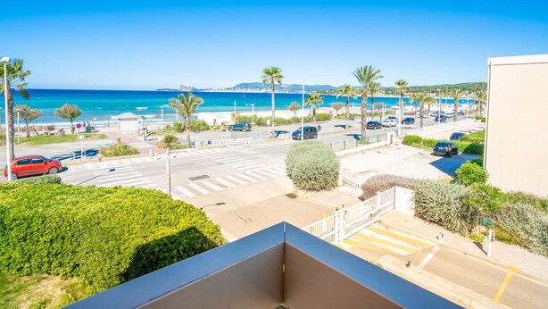 A coastal view with a parking lot, palm trees, and a clear blue sky. - La Sirene by Interhome (Saint Cyr sur mer Les Lecques)