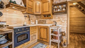 A wooden cabin-style kitchen with a built-in oven, wooden cabinets, and a rustic aesthetic. - Plitvice I by Interhome (Plitvice)
