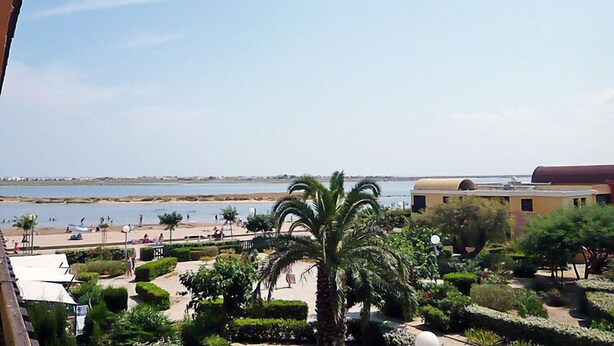 A coastal resort with a beach, palm trees, and a view of the sea. - Gruissan Plage by Interhome (Gruissan)