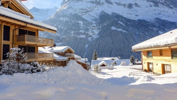 A snow-covered mountain village with wooden buildings, a wooden staircase, and a snow-covered path. - Chalet Butz by Interhome (Grindelwald)