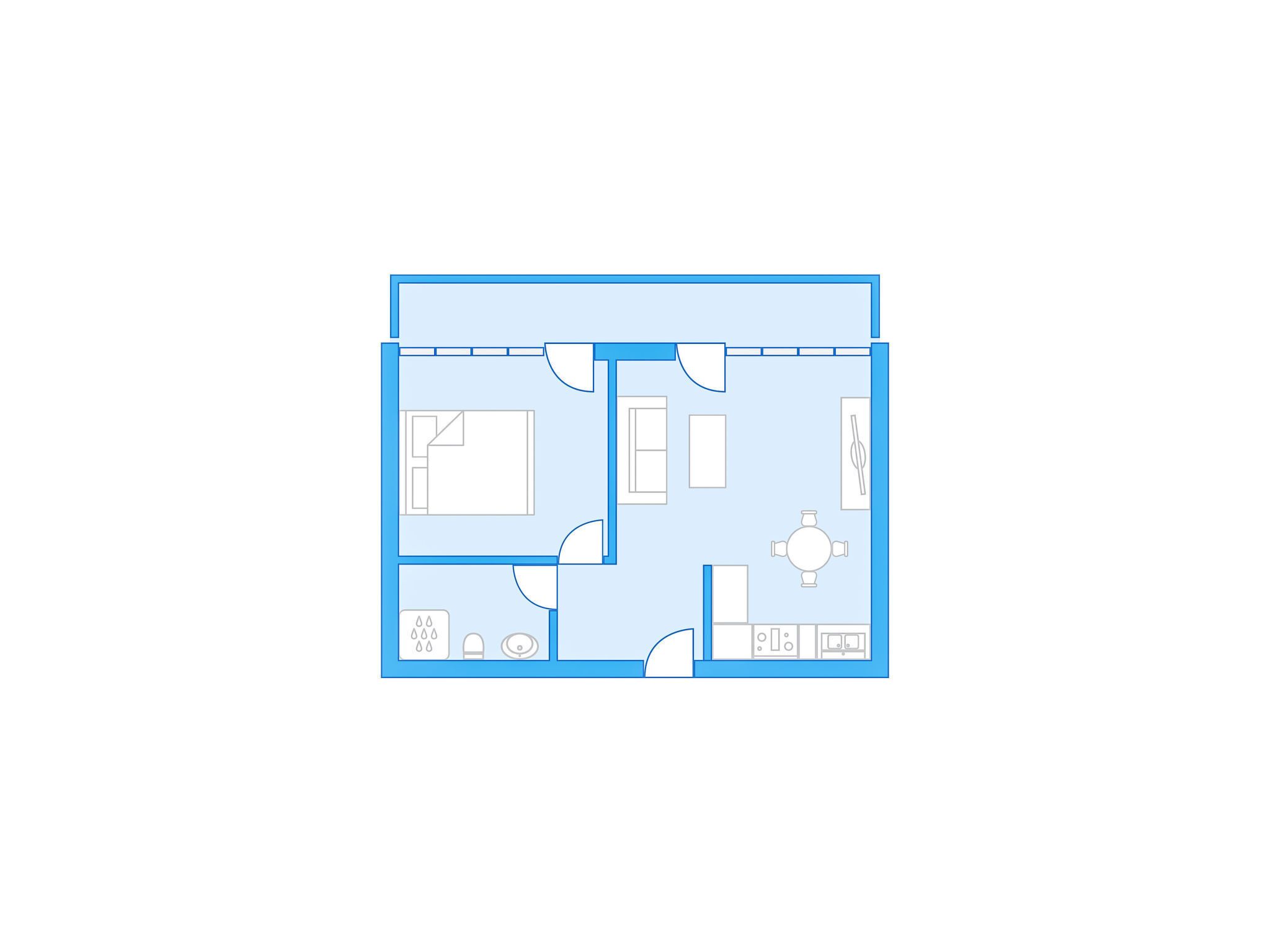 Plano de un cuarto de hotel con cama, escritorio, silla, una mesita, sofá y baño con inodoro y lavamanos.