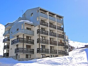 A multi-story hotel with balconies, located in a snowy area. - Plein Soleil (Val Claret) by Interhome (Tignes)