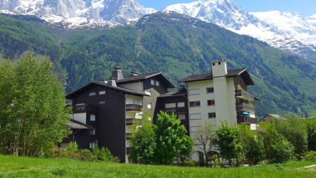 A hotel with multiple buildings, surrounded by lush greenery and snow-capped mountains in the background. - Clos du Savoy by Interhome (Chamonix)
