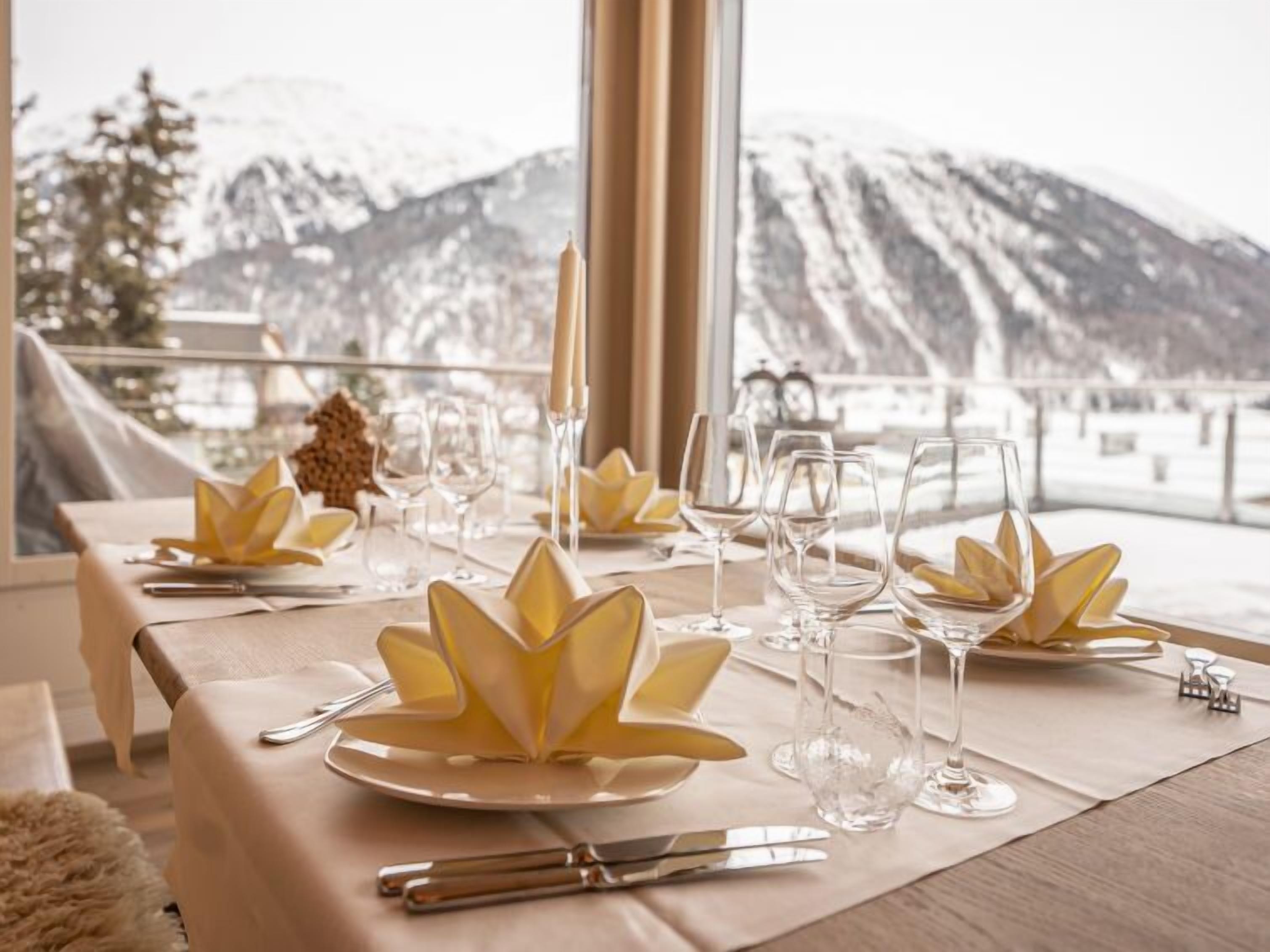 A table set for a meal with a mountain view.