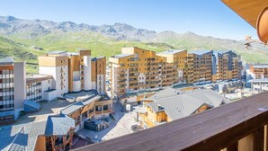 A modern hotel complex with multiple buildings, a central courtyard, and a mountainous backdrop. - Roche Blanche 183 by Interhome (Val Thorens)