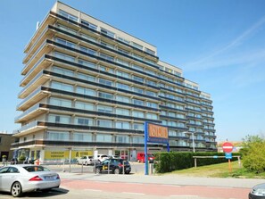 A multi-story hotel with a modern design, featuring balconies on each floor and a visible sign for 'ASTRID'.