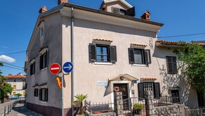 A two-story building with a sign reading "APARTMAN" and a no entry sign. - Lovrano by Interhome (Lovran)