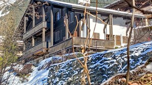 A wooden chalet with a balcony, set against a snowy mountain backdrop. - Apartment Biwak by Interhome (Wengen)