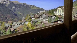 A mountain village with traditional wooden buildings, a ski lift, and a view of the surrounding mountains. - Apartment Biwak by Interhome (Wengen)