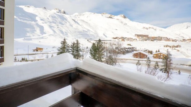 A snowy mountain landscape with a town in the background. - Le Slalom (Val Claret) by Interhome (Tignes)