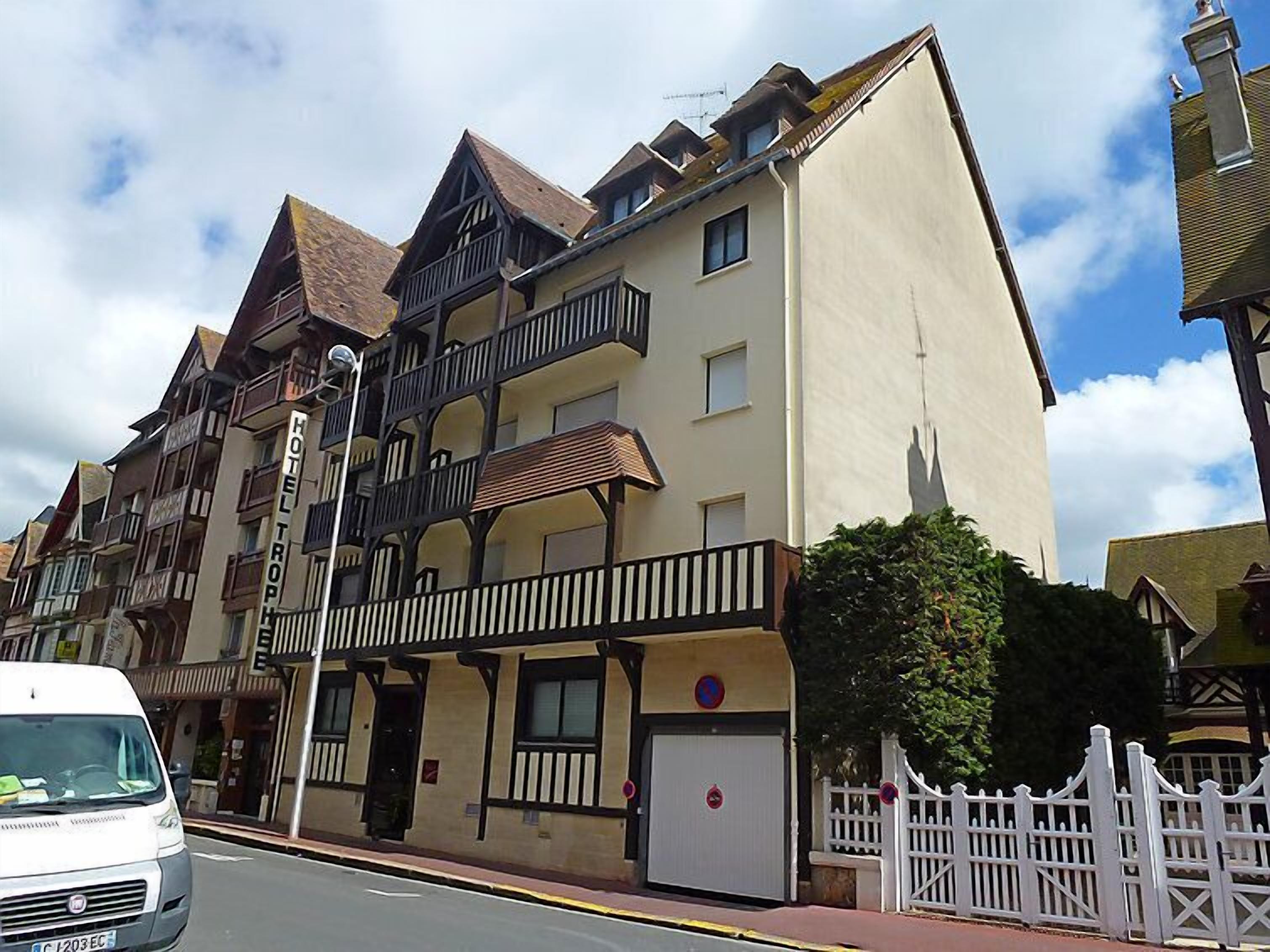 A hotel with a traditional European architectural style, featuring multiple balconies and a prominent entrance.