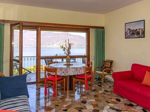 Enjoy a serene view of the water and distant mountains from this room's large window.