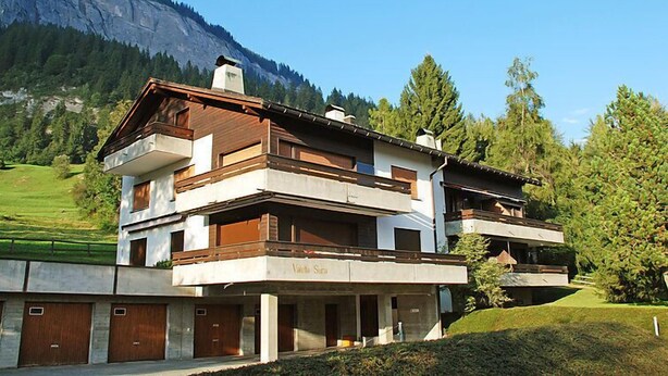 A modern two-story chalet with a wooden facade, set against a mountainous backdrop. - Valetta Sura by Interhome (Flims)