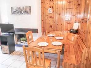 Enjoy intimate meals and entertainment in this well-appointed dining area with a table for four, TV, and comfortable seating.