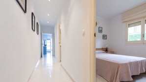 A hotel corridor with a bed and a window in the room. - Gladiols by Interhome (Cambrils)