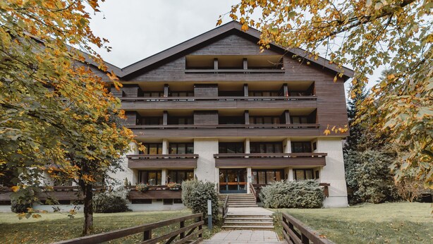 A multi-story hotel with a central staircase leading to the entrance.