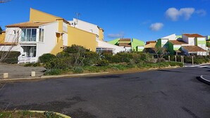 A row of colorful houses with a clear blue sky. - Les Balcons de la Méditerranée by Interhome (Narbonne-Plage)