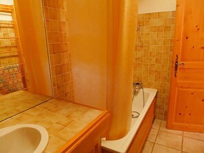 A bathroom with a bathtub, a toilet, and a shower area. - Chalet Le Tour by Interhome (Argentière)