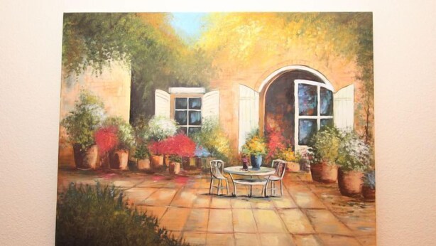 A painting of a garden patio with a table and chairs, surrounded by potted plants and a building with arched windows. - Am Birkenhain by Interhome (Seefeld in Tirol)