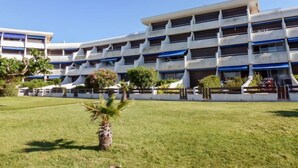 A multi-story building with a modern architectural design, featuring a series of balconies and a flat roof.