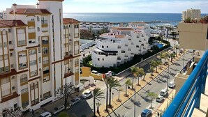 A coastal residential area with white buildings, a clear sky, and a view of the sea. - Bellavista del Puerto by Interhome (Estepona)